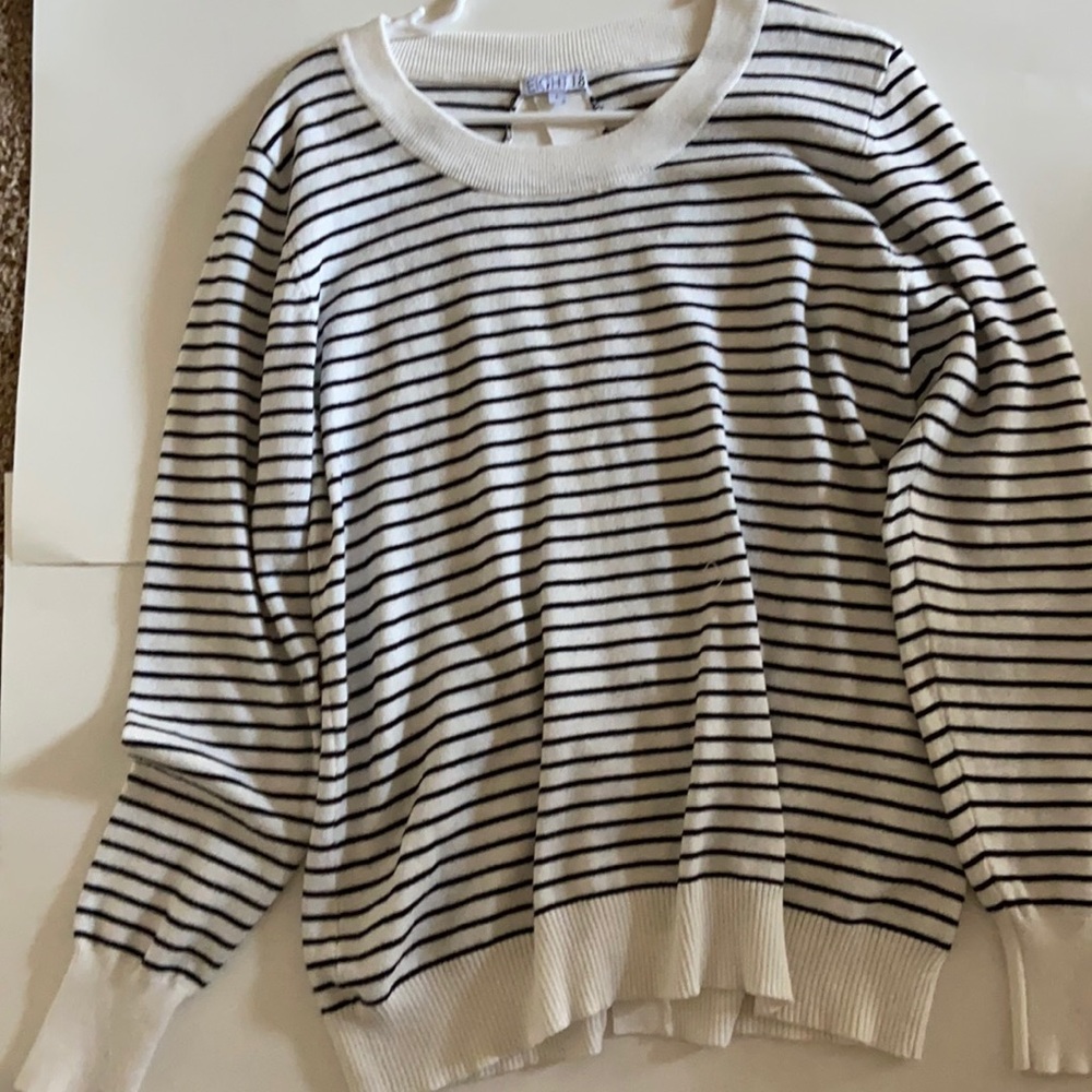 White with black striped long sleeve sweater.